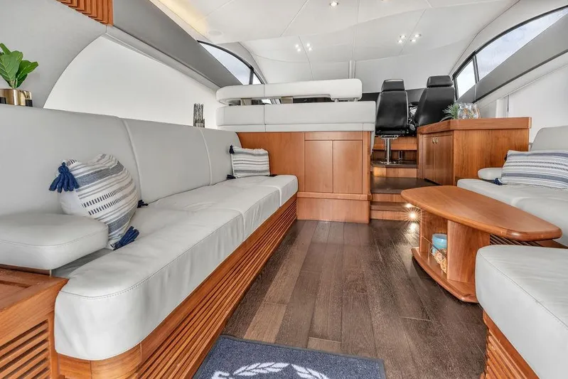 Ohana Forever Yacht Photos Pics Luxurious interior of 2016 Sunseeker Manhattan 55 yacht with elegant seating and wooden accents.