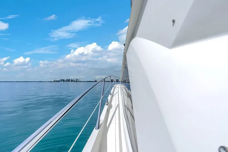 Ohana Forever Yacht Photos Pics 2016 Sunseeker Manhattan 55 yacht cruising on calm blue waters under a clear sky.