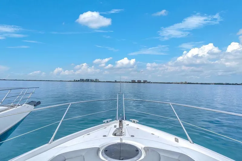Ohana Forever Yacht Photos Pics Bow view from 2016 Sunseeker Manhattan 55 yacht on calm ocean under blue sky.