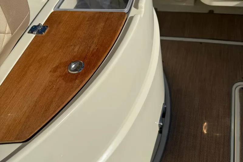  Yacht Photos Pics 2019 Chris-Craft Catalina 30 interior with wooden panel and beige seating.