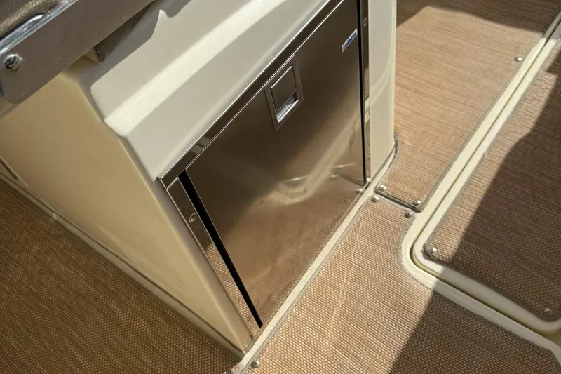  Yacht Photos Pics 2019 Chris-Craft Catalina 30 interior with stainless steel refrigerator and beige flooring.