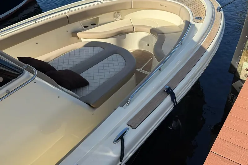  Yacht Photos Pics 2019 Chris-Craft Catalina 30 boat with elegant seating and wood accents docked by the water.