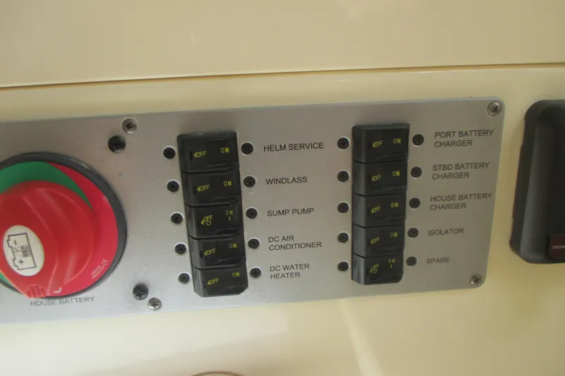  Yacht Photos Pics Control panel of a 2019 Chris-Craft Catalina 30 boat with various switches and battery controls.