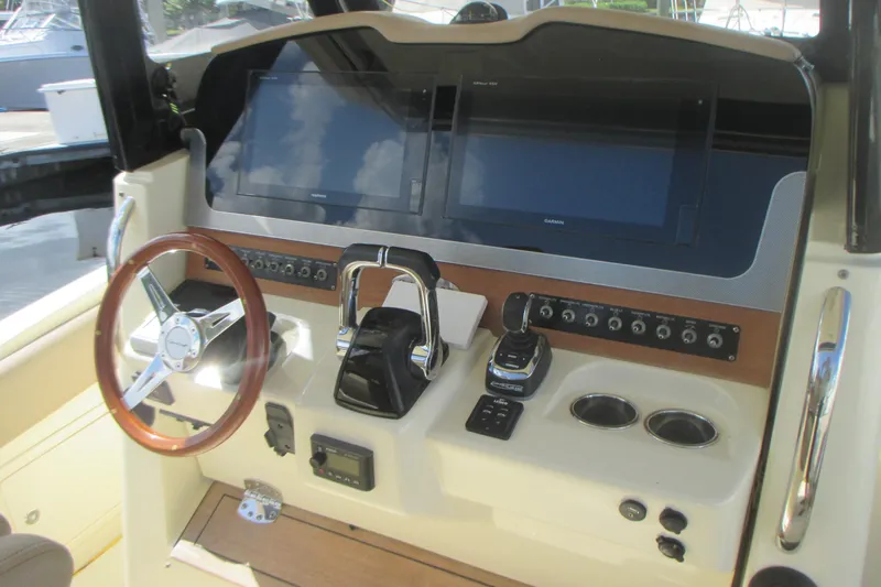  Yacht Photos Pics 2019 Chris-Craft Catalina 30 helm with dual screens, steering wheel, and controls.