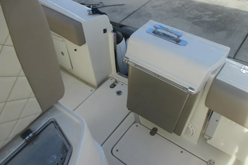  Yacht Photos Pics 2019 Chris-Craft Catalina 30 interior with beige seating and storage compartment.