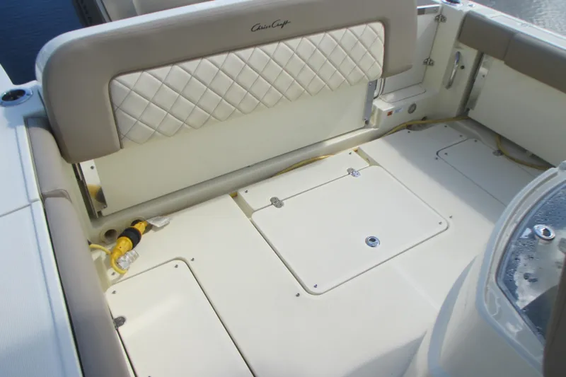  Yacht Photos Pics 2019 Chris-Craft Catalina 30 boat interior with cushioned seating and storage compartments.