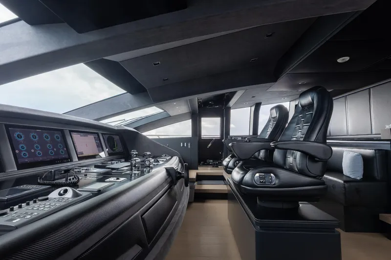 Goldeneye Yacht Photos Pics Luxurious interior of 2020 Mangusta 54 Gransport yacht with modern control panel and seating.