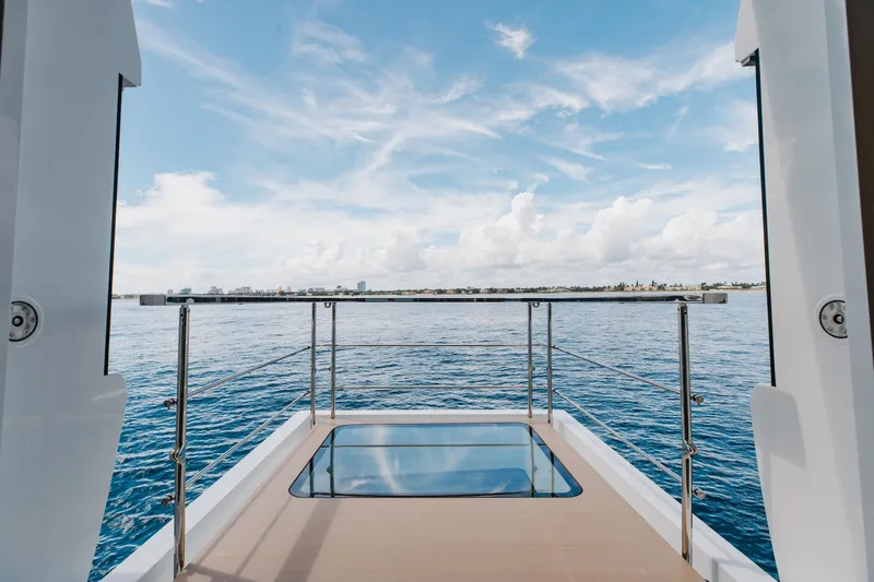 Goldeneye Yacht Photos Pics Mangusta 54 Gransport 2020 yacht deck with ocean view and glass floor panel.