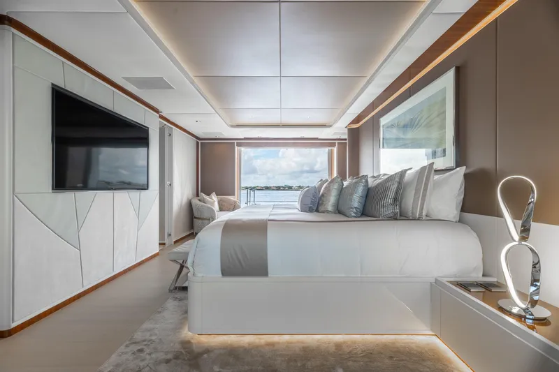 Goldeneye Yacht Photos Pics Luxurious bedroom interior of 2020 Mangusta 54 Gransport yacht with modern decor and ocean view.