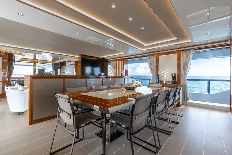Goldeneye Yacht Photos Pics Luxurious interior of 2020 Mangusta 54 Gransport yacht with elegant dining area and ocean view.