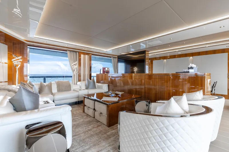 Goldeneye Yacht Photos Pics Luxurious interior of 2020 Mangusta 54 Gransport yacht with elegant seating and ocean view.