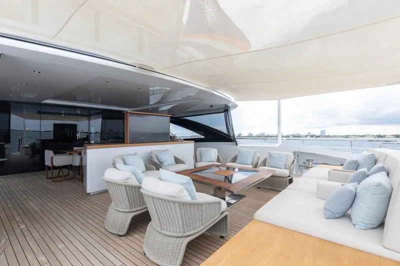 Goldeneye Yacht Photos Pics Luxurious deck of 2020 Mangusta 54 Gransport yacht with elegant seating and ocean view.