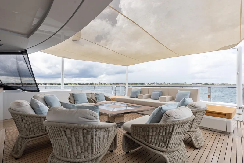 Goldeneye Yacht Photos Pics Luxurious outdoor seating on 2020 Mangusta 54 Gransport yacht, with ocean view and canopy.