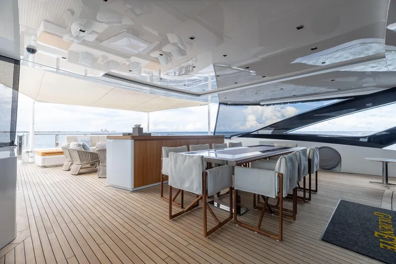 Goldeneye Yacht Photos Pics Luxurious deck of 2020 Mangusta 54 Gransport yacht with elegant seating and ocean view.