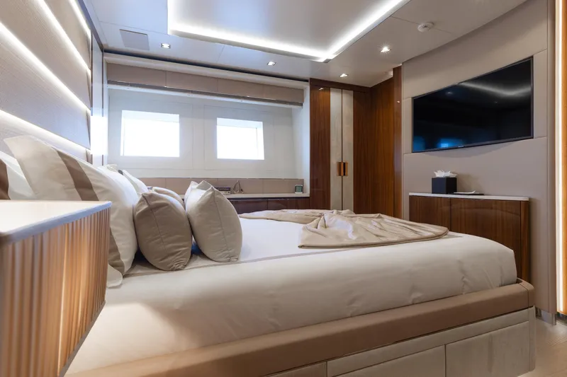 Goldeneye Yacht Photos Pics Luxurious bedroom interior of 2020 Mangusta 54 Gransport yacht with modern design elements.