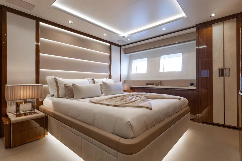 Goldeneye Yacht Photos Pics Luxurious bedroom interior on 2020 Mangusta 54 Gransport yacht, featuring elegant design and ambient lighting.