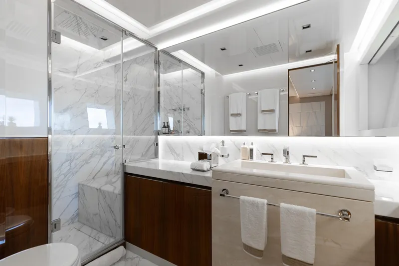 Goldeneye Yacht Photos Pics Luxurious bathroom in 2020 Mangusta 54 Gransport yacht, featuring marble and modern fixtures.