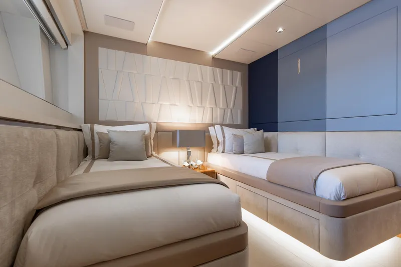 Goldeneye Yacht Photos Pics Luxurious bedroom interior on 2020 Mangusta 54 Gransport yacht, featuring modern twin beds.