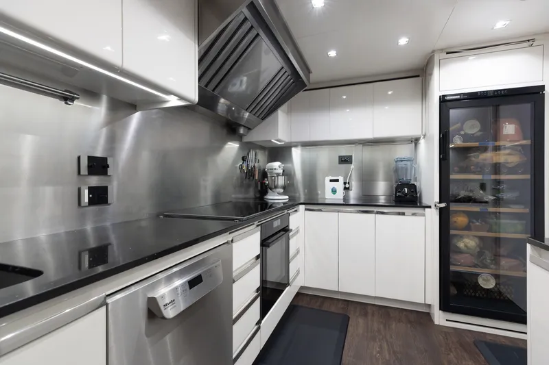 Goldeneye Yacht Photos Pics Modern kitchen interior on 2020 Mangusta 54 Gransport yacht, featuring sleek appliances and cabinetry.