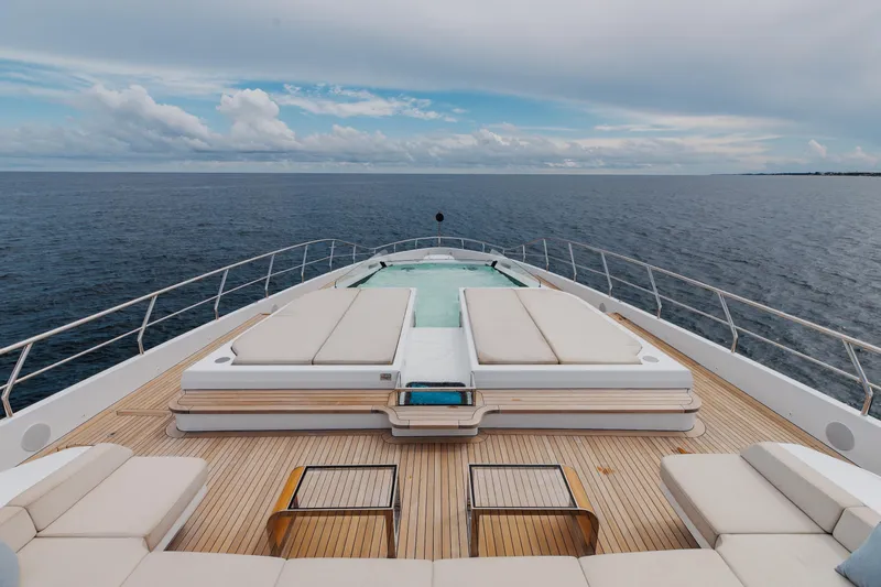 Goldeneye Yacht Photos Pics Luxurious 2020 Mangusta 54 Gransport yacht deck with sun loungers and ocean view.