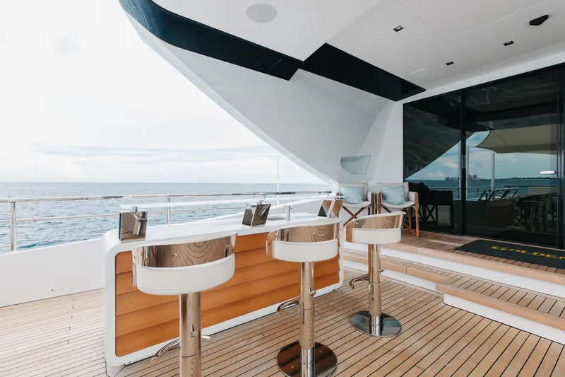 Goldeneye Yacht Photos Pics Luxurious 2020 Mangusta 54 Gransport yacht deck with modern bar stools and ocean view.