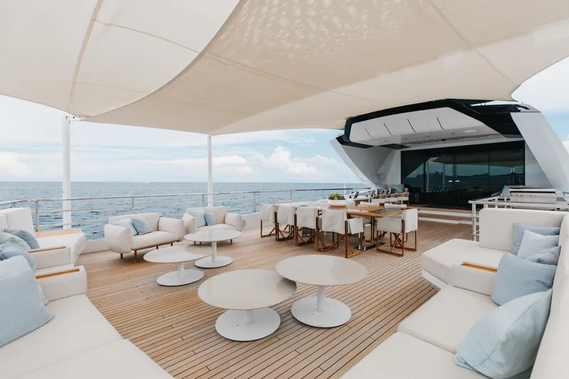 Goldeneye Yacht Photos Pics Luxurious deck of 2020 Mangusta 54 Gransport yacht with elegant seating and ocean view.