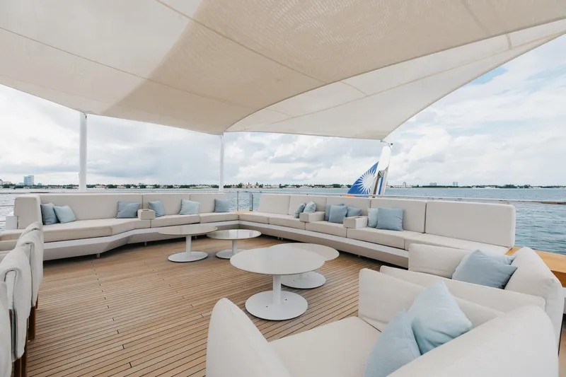 Goldeneye Yacht Photos Pics Luxurious deck of 2020 Mangusta 54 Gransport yacht with elegant seating and ocean view.