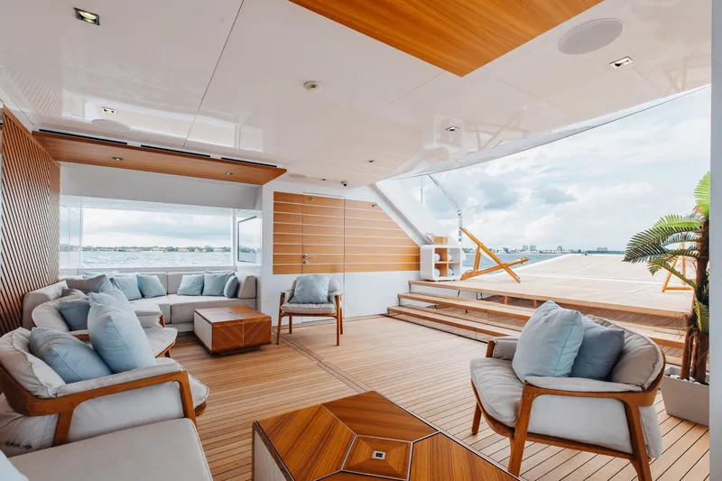 Goldeneye Yacht Photos Pics Luxurious 2020 Mangusta 54 Gransport yacht interior with elegant seating and wooden accents.