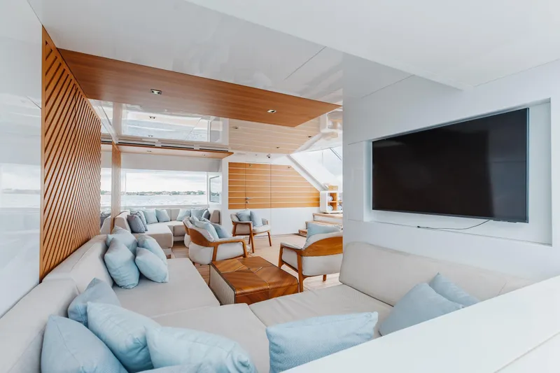 Goldeneye Yacht Photos Pics Luxurious interior of 2020 Mangusta 54 Gransport yacht with modern seating and large TV.