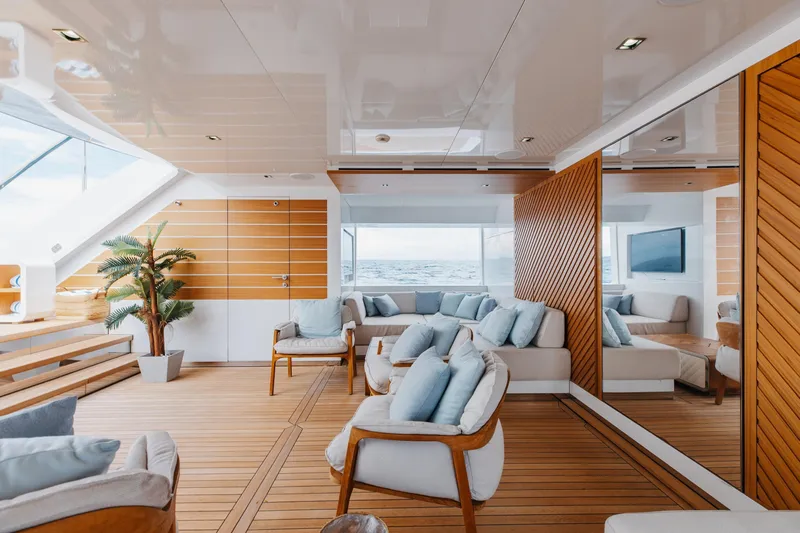Goldeneye Yacht Photos Pics Luxurious interior of 2020 Mangusta 54 Gransport yacht with modern seating and ocean view.