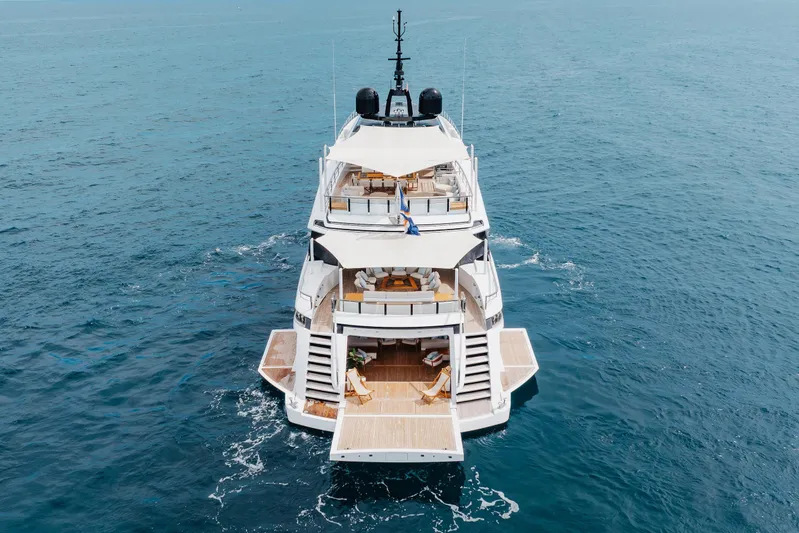 Goldeneye Yacht Photos Pics Luxury 2020 Mangusta 54 Gransport yacht cruising on open sea, showcasing elegant design.
