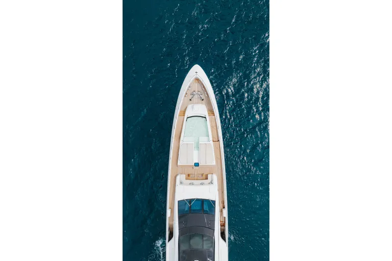 Goldeneye Yacht Photos Pics Aerial view of 2020 Mangusta 54 Gransport yacht on blue ocean water.