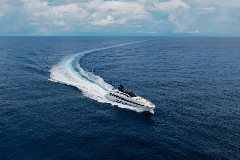 Goldeneye Yacht Photos Pics Luxury yacht Mangusta 54 Gransport 2020 cruising on open ocean under blue sky.