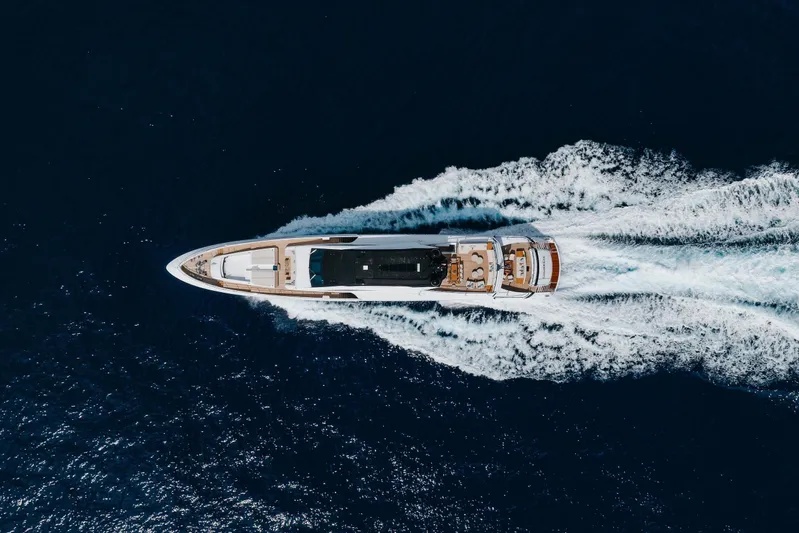 Goldeneye Yacht Photos Pics Aerial view of 2020 Mangusta 54 Gransport yacht cruising on open sea.