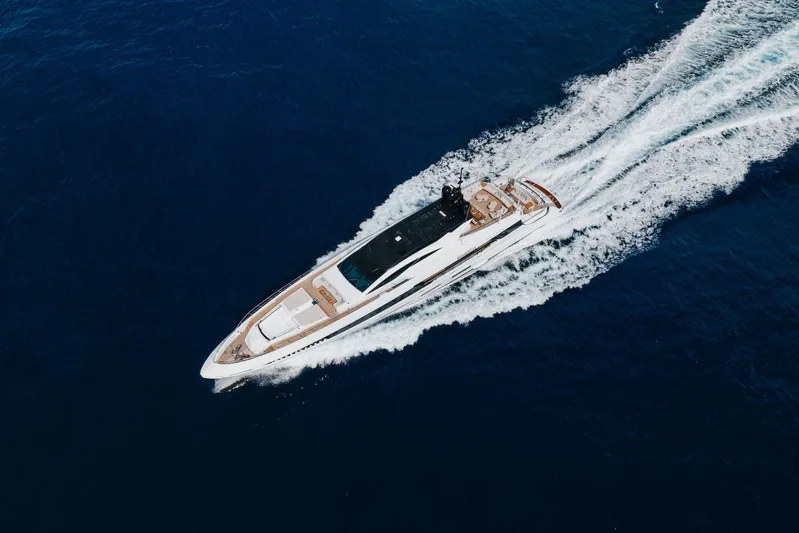 Goldeneye Yacht Photos Pics Aerial view of 2020 Mangusta 54 Gransport yacht cruising on open sea.