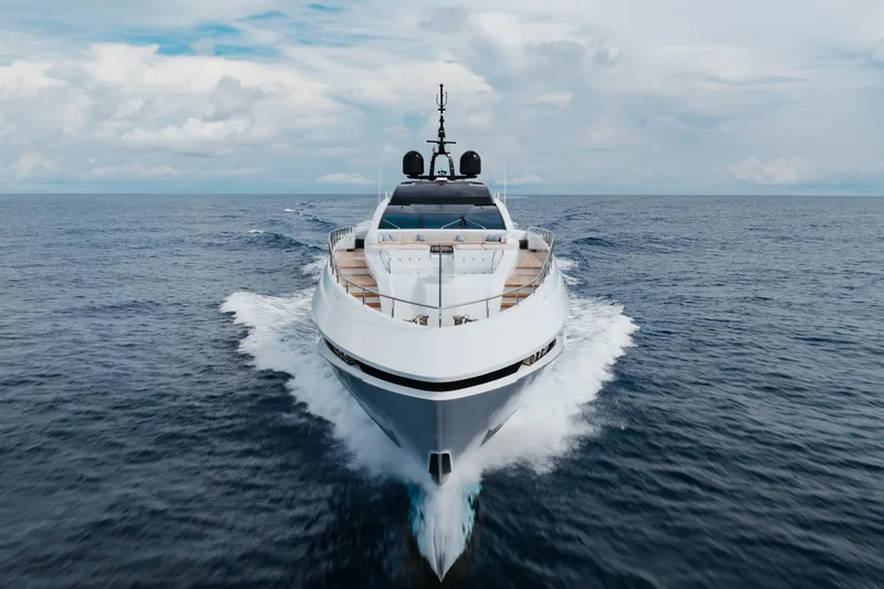 Goldeneye Yacht Photos Pics 2020 Mangusta 54 Gransport yacht cruising on open sea under cloudy sky.