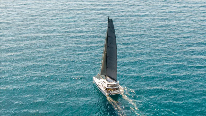 Noble House Yacht Photos Pics Aerial view of 2019 McConaghy MC60 sailing on open blue sea.