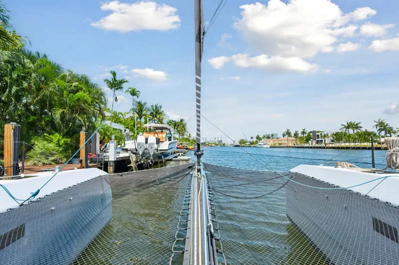 Noble House Yacht Photos Pics 2019 McConaghy MC60 catamaran docked in a tropical marina setting.