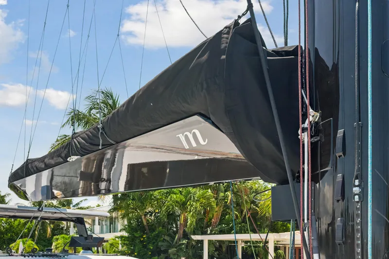 Noble House Yacht Photos Pics 2019 McConaghy MC60 yacht mast with black sail cover, tropical background.