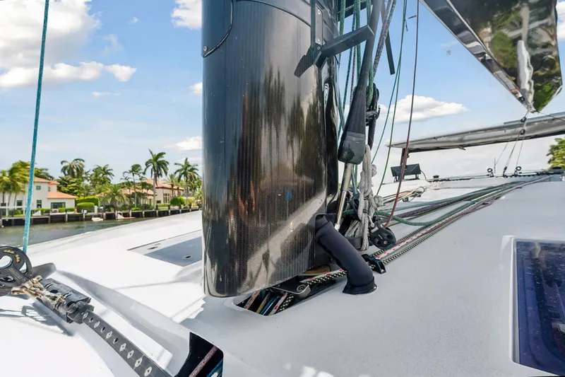 Noble House Yacht Photos Pics 2019 McConaghy MC60 yacht deck with mast and rigging, palm trees in background.