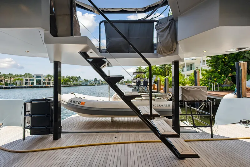 Noble House Yacht Photos Pics Luxury McConaghy MC60 yacht deck with stairs and tender, 2019 model.