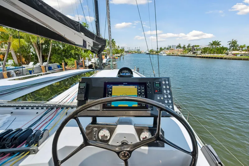 Noble House Yacht Photos Pics 2019 McConaghy MC60 yacht helm with navigation system, cruising on a scenic waterway.