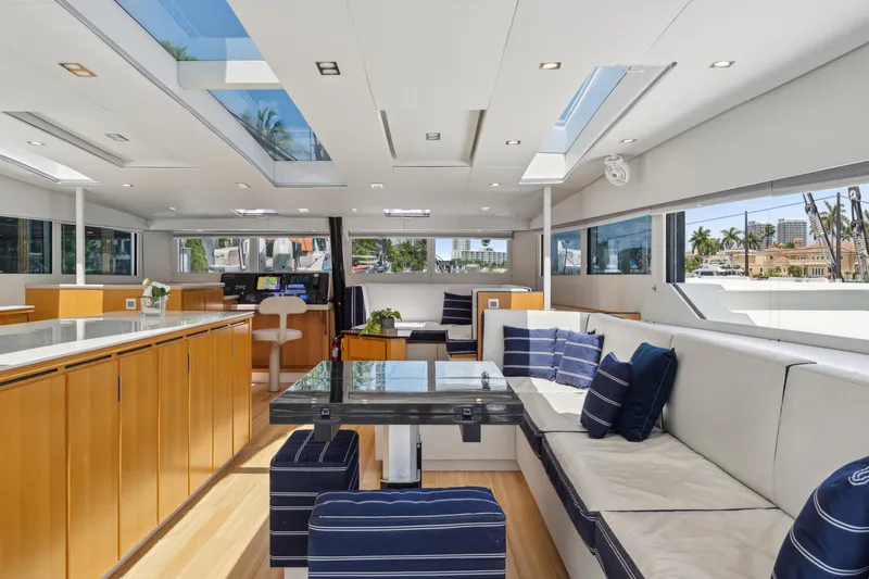 Noble House Yacht Photos Pics Luxurious interior of 2019 McConaghy MC60 yacht with modern furnishings and panoramic windows.