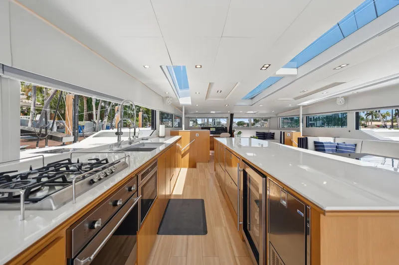 Noble House Yacht Photos Pics Luxurious interior of 2019 McConaghy MC60 yacht with modern kitchen and sleek design.