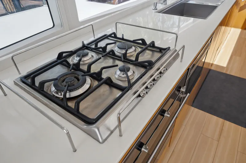 Noble House Yacht Photos Pics Modern kitchen with a four-burner gas stove on a McConaghy MC60 yacht, 2019 model.