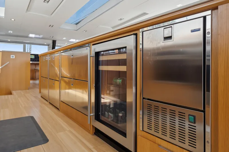 Noble House Yacht Photos Pics Luxurious 2019 McConaghy MC60 yacht interior with modern kitchen appliances and sleek wood finishes.