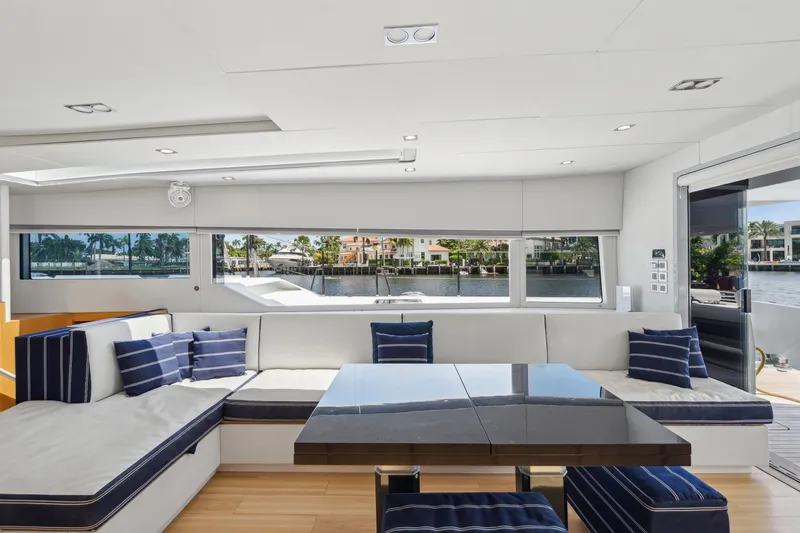 Noble House Yacht Photos Pics Luxurious interior of 2019 McConaghy MC60 yacht with modern seating and waterfront view.
