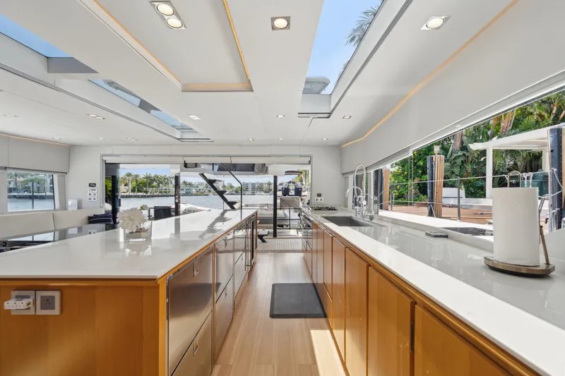 Noble House Yacht Photos Pics Luxurious interior of 2019 McConaghy MC60 yacht with modern kitchen and scenic views.