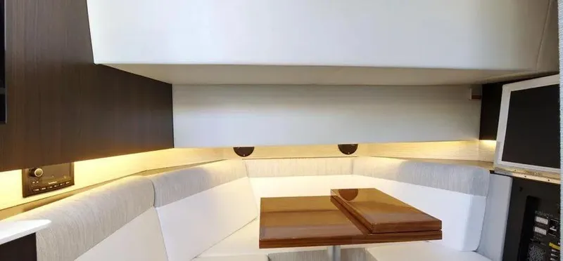  Yacht Photos Pics 2023 Cruisers Yachts 38 GLS interior with modern seating and wooden table.
