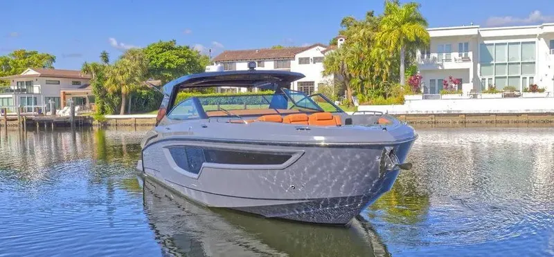  Yacht Photos Pics 2023 Cruisers Yachts 38 GLS on serene water near luxury waterfront homes.